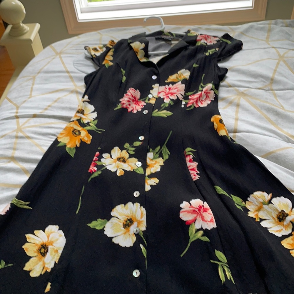 Black collared dress with colorful flowers.